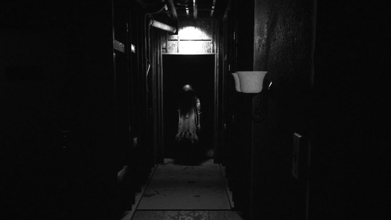 Screenshot of Visage showing a creepy girl at the end of a dark corridor..