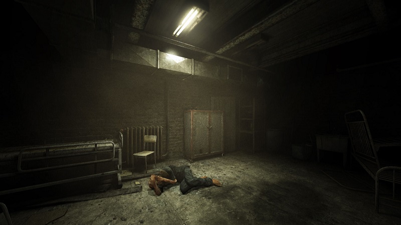 Screenshot from the first Outlast game showing a man in the fetal position on a dirty floor.