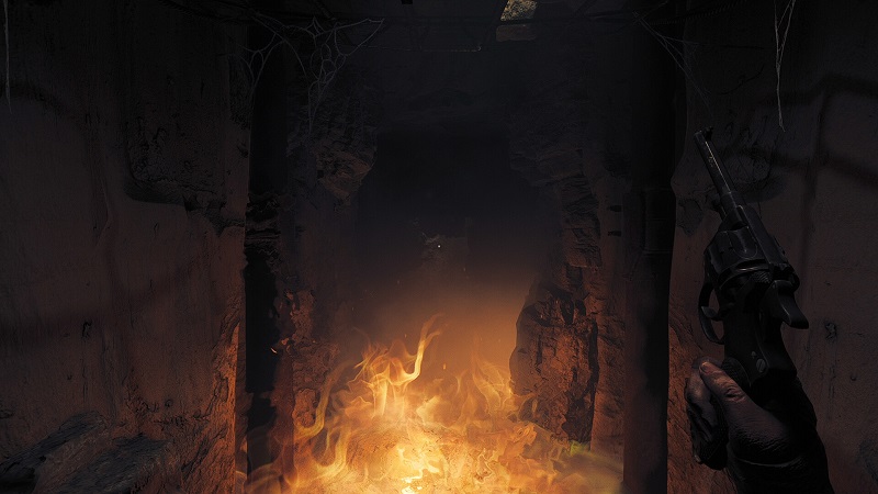 Image from Amnesia: The Bunker showing a fire in a dark tunnel.