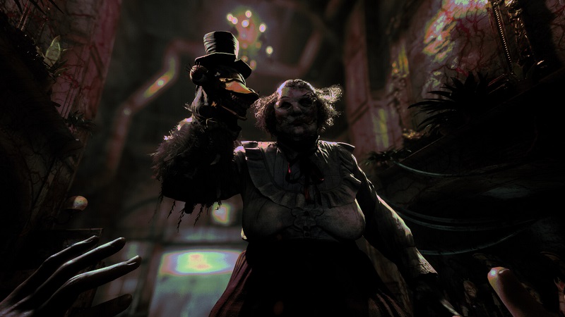 The Outlast Trials: Mother Gooseberry holding a glove puppet and looking menacingly down at the player.