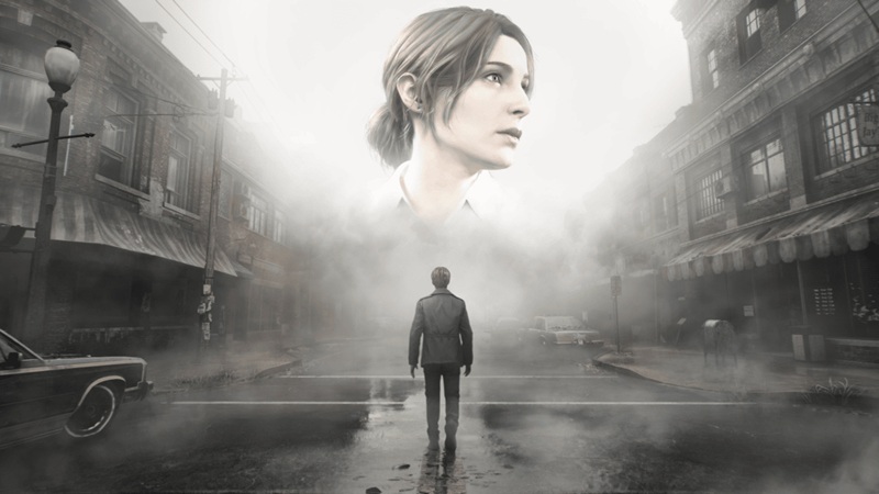 Silent Hill 2: a man walks down a foggy street as a large female head watches over him.