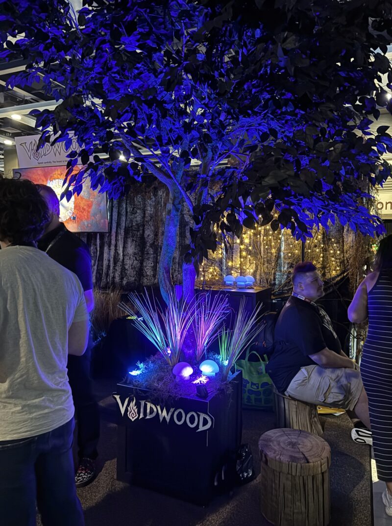 PAX West 2026: A tree is bathed in a neon blue glow.
