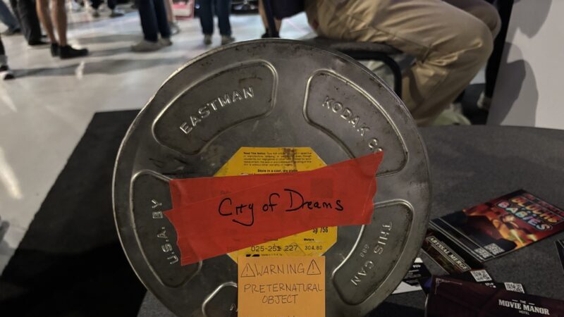 PAX West 2026: An image of a film reel replica, that says "City of Dream" in red tape on the cover.