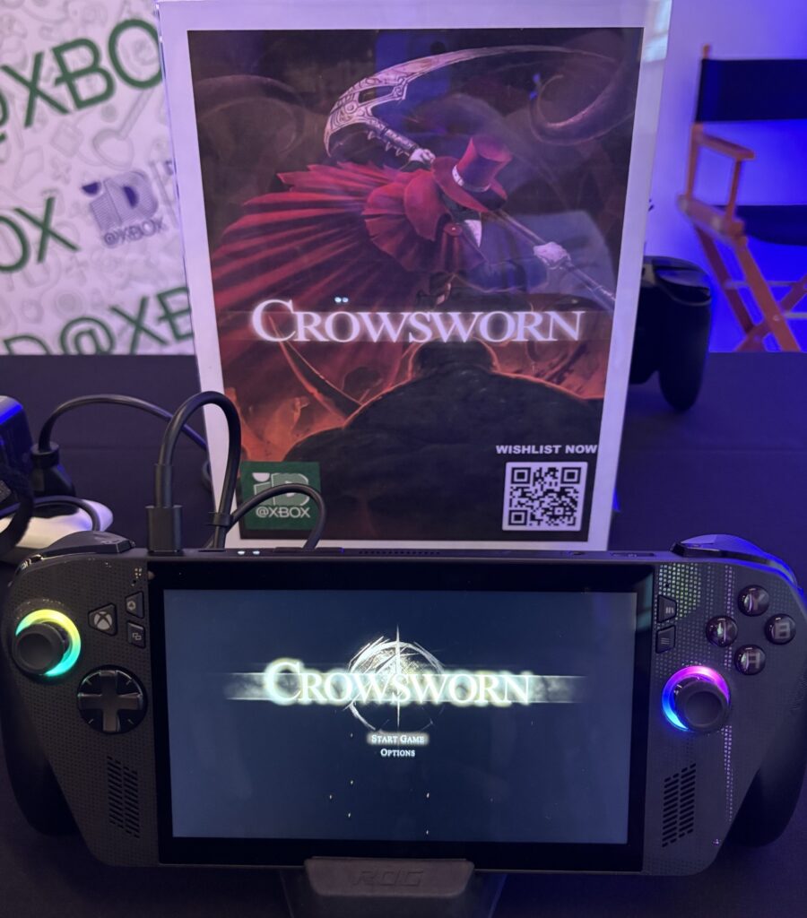PAX West 2026: A handheld games device with the Crownsworn logo on the screen.