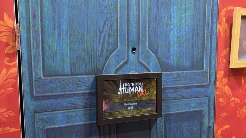 PAX West 2026: a blue door with a sign on that says "No, I;m not Human IRL" on it.