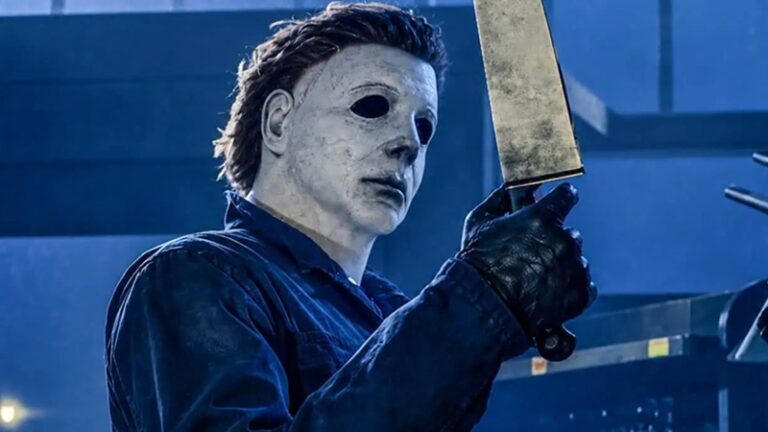 Halloween: Michael Myers, in his trademark white mask, holds up a sharp blade.