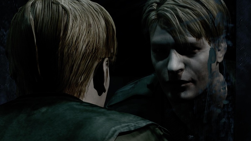 Silent Hill 2: a man with blonde hair stares at his reflection in a dark mirror.